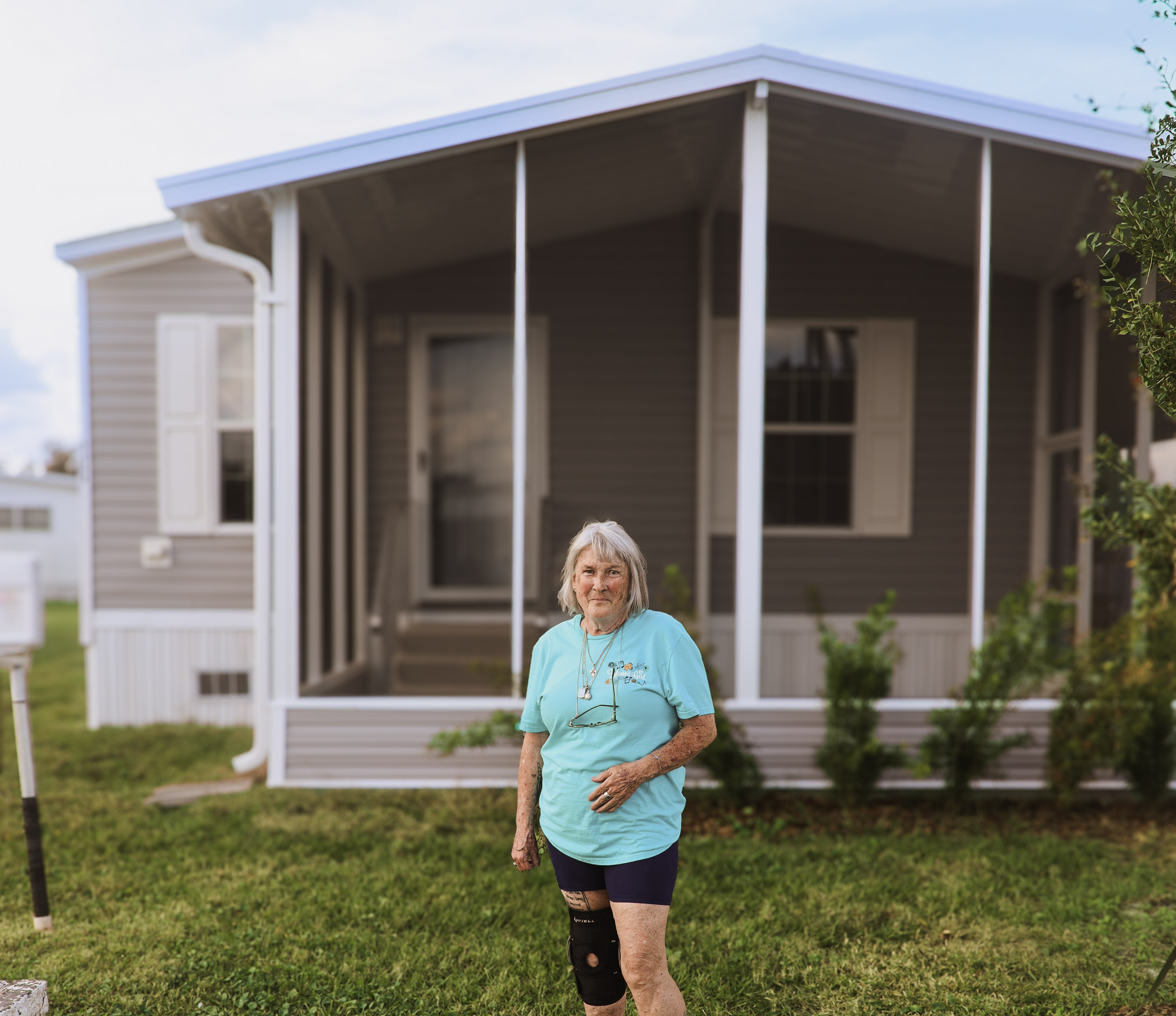 Deborah Groover stands in front of her home.